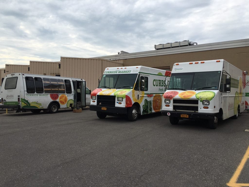 The new vehicle, middle, pictured with the other two Curbside trucks at Foodlink