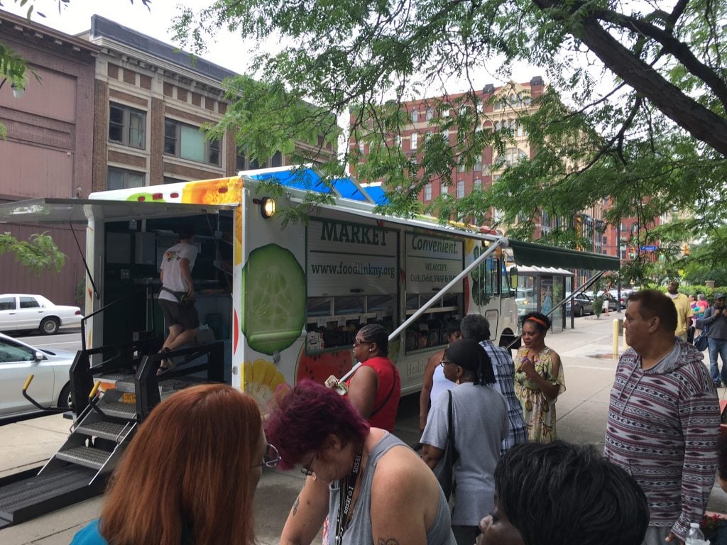 Customers get ready to board the Curbside Market on Aug. 16 at Andrews Terrace in Rochester.