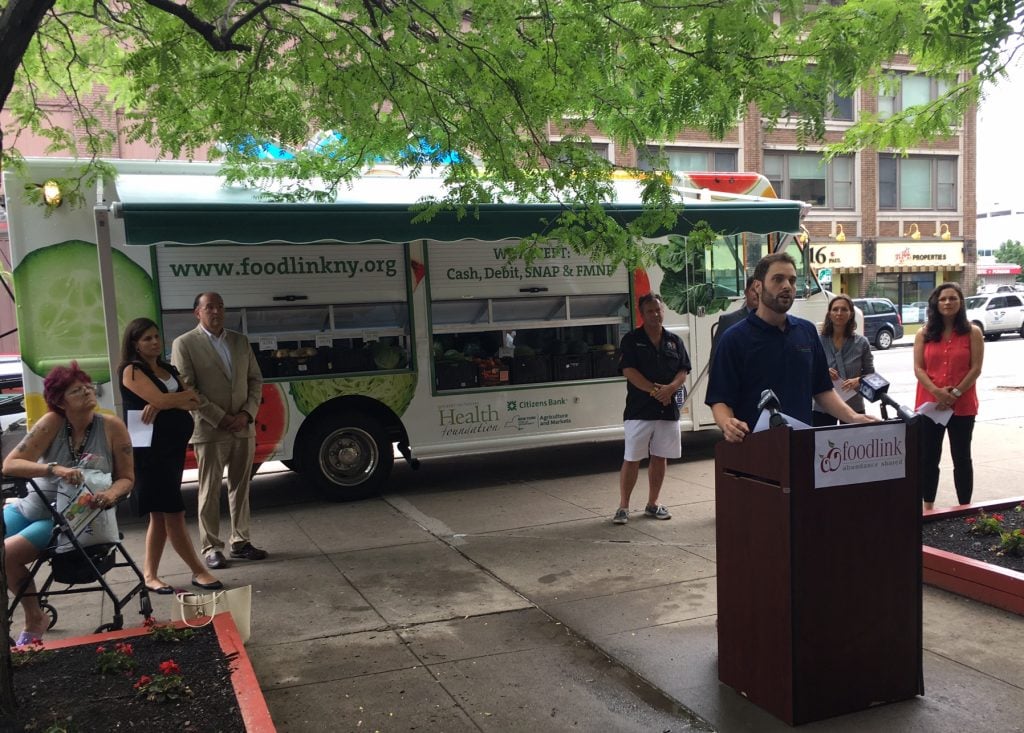 Chief Program Officer Mitch Gruber discusses the third Curbside Market vehicle and the Double Up Food Bucks program Aug. 16 at Andrews Terrace in Rochester.