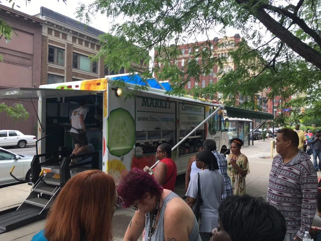 Customers get ready to board the Curbside Market on Aug. 16 at Andrews Terrace in Rochester.